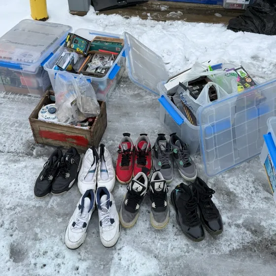 Seven pairs of Air Jordans and storage bins pulled out of the unit onto the snow